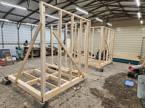 Bare stud framing for the first saunas in the shop