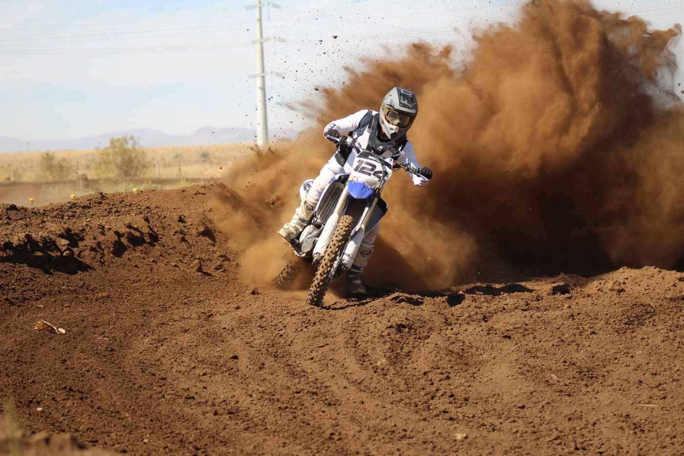 Racing motocross in a spray of dirt