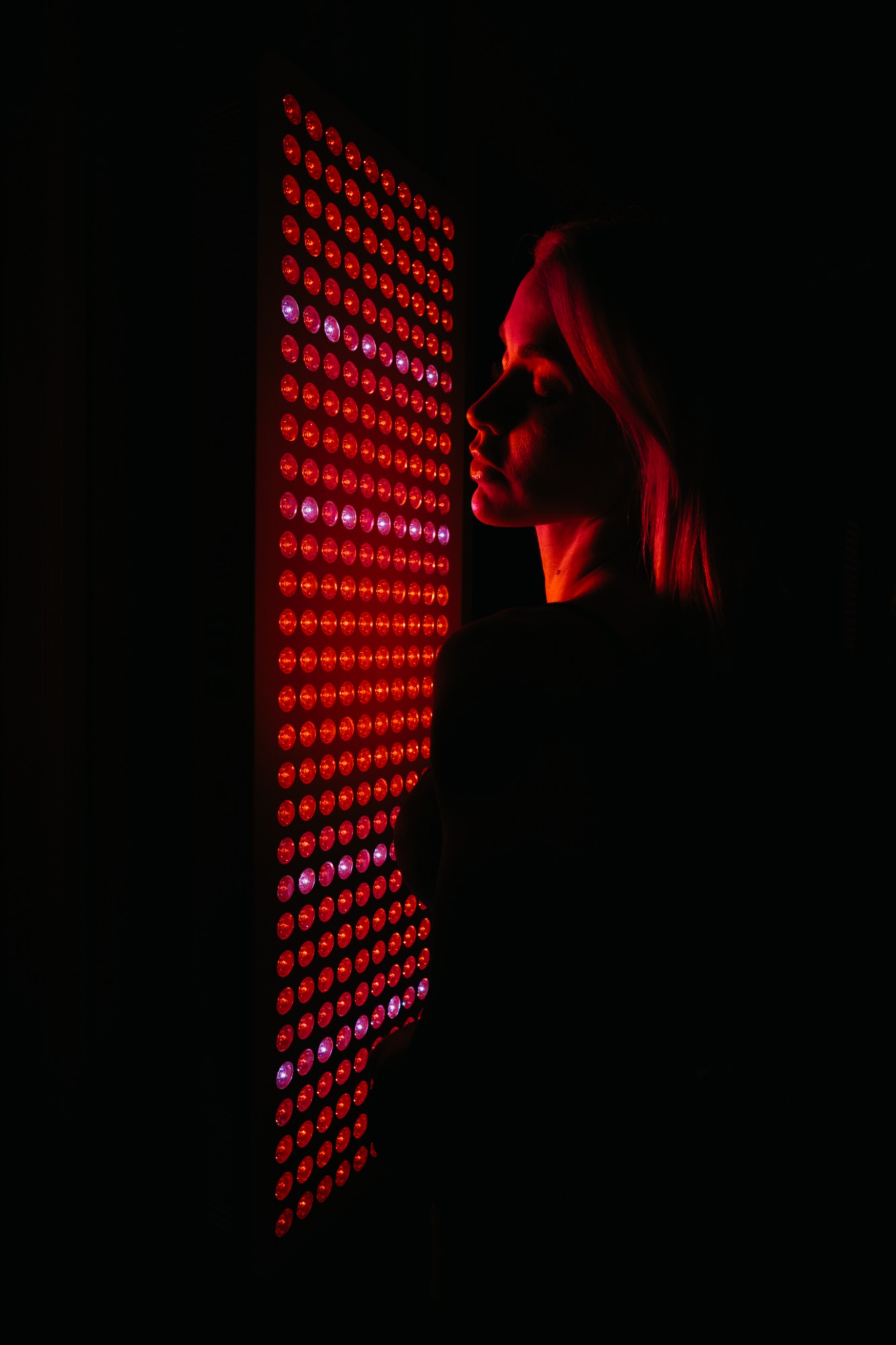 The lit panel in profile in a dark room