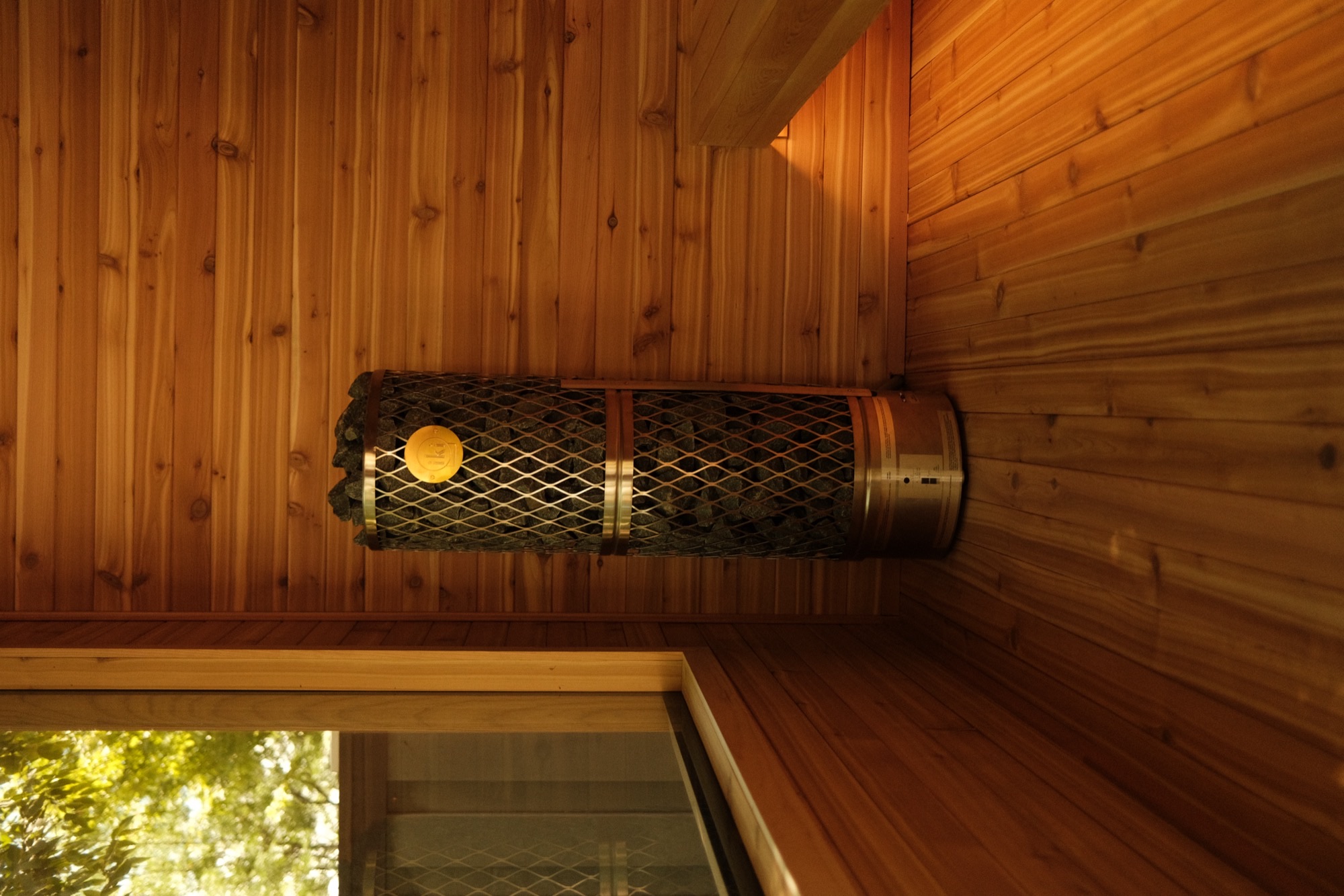 IKI Pillar heater and cedar bench, lit by the window