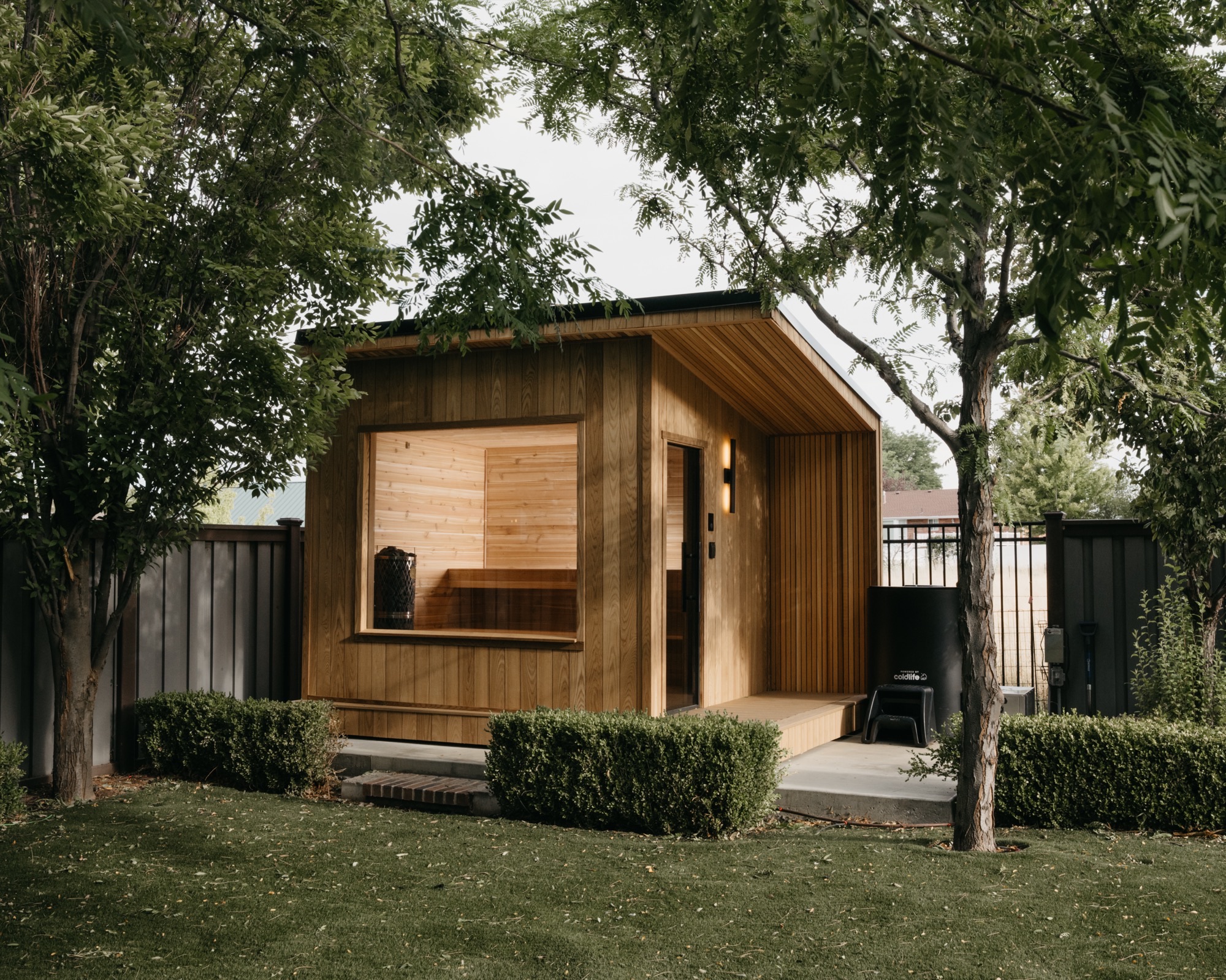 212 Designer framed by mature trees with a Cold Life plunge beside the porch