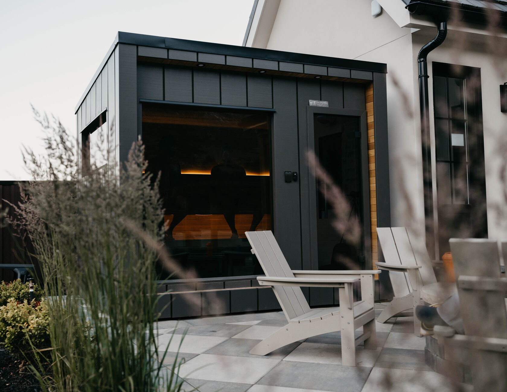 212 sauna exterior, charred black envelope at dusk