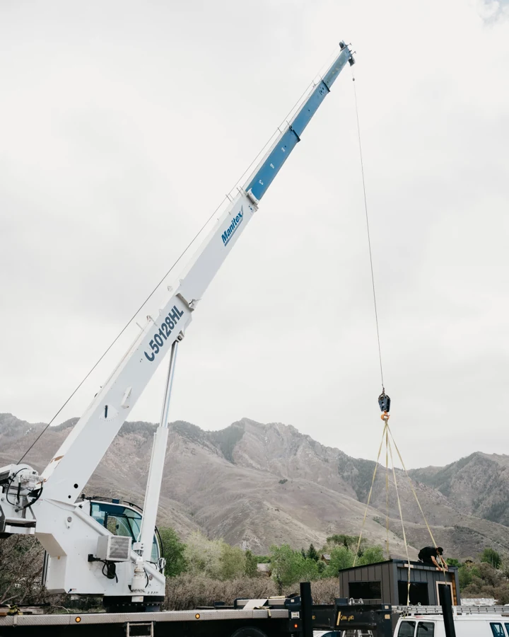 Crane positioned beside the property for delivery of the 212 Essential