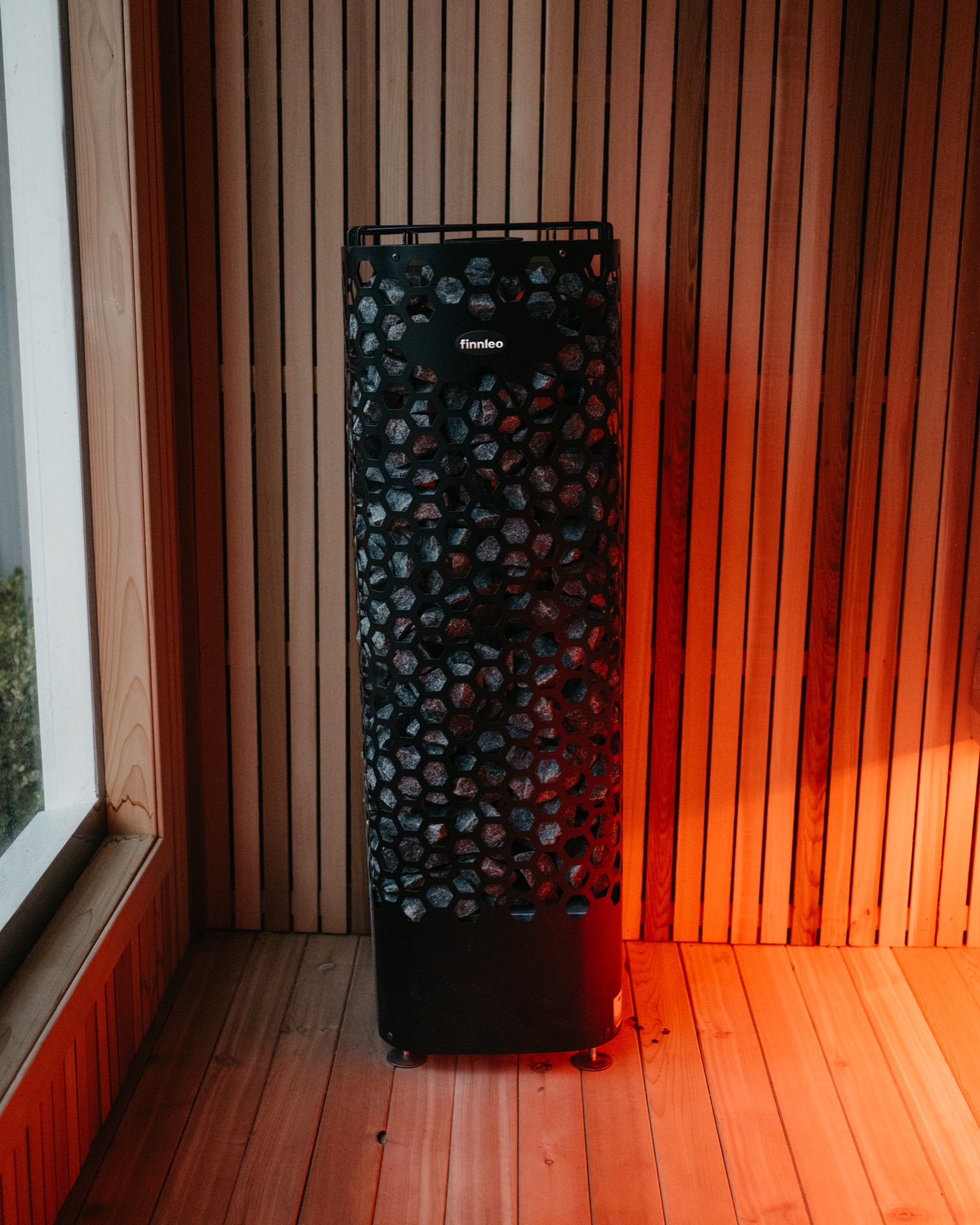 A stone-filled sauna heater radiating slow heat