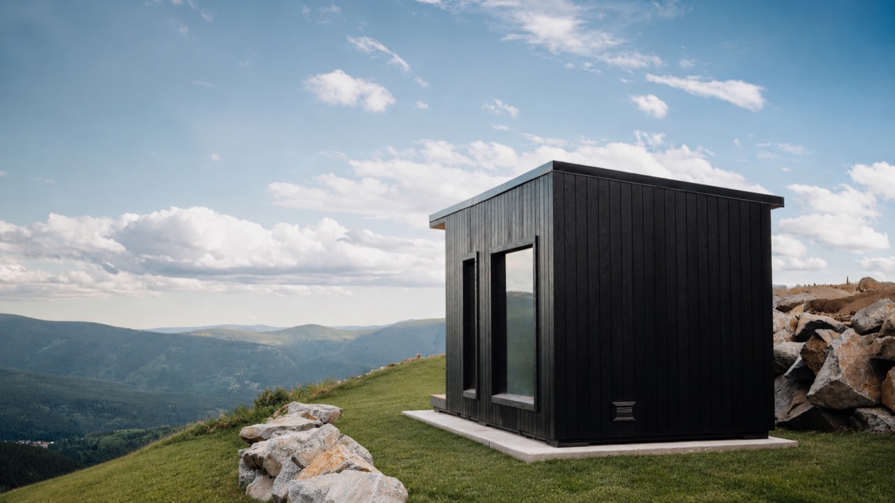 Thermal Suite Designer with a black timber exterior overlooking the mountains