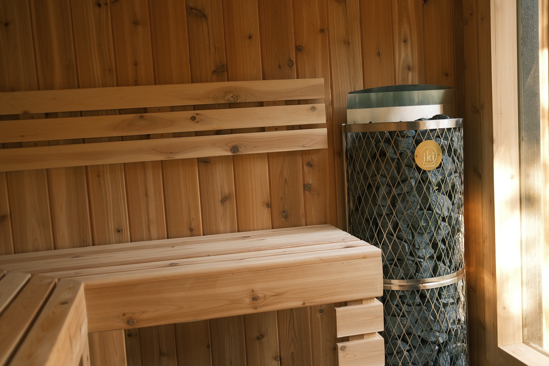 Cedar bench and IKI heater inside the Thermal Suite Essential