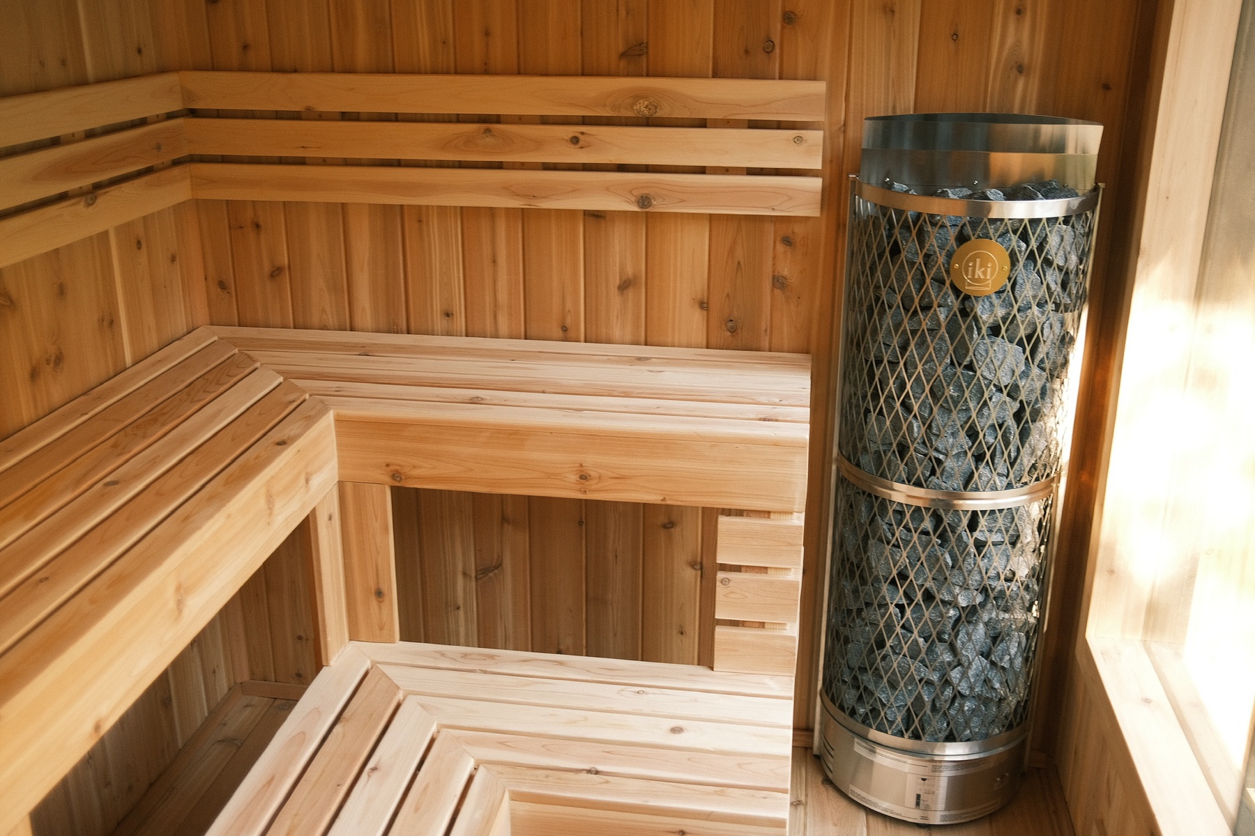 Two-tier cedar benches and IKI heater inside the Thermal Suite Essential
