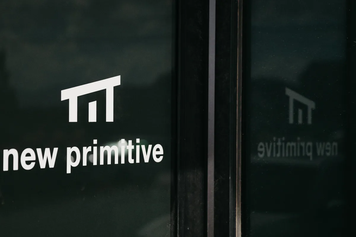 The front door at the New Primitive factory in Woods Cross, Utah, with the wordmark on the glass