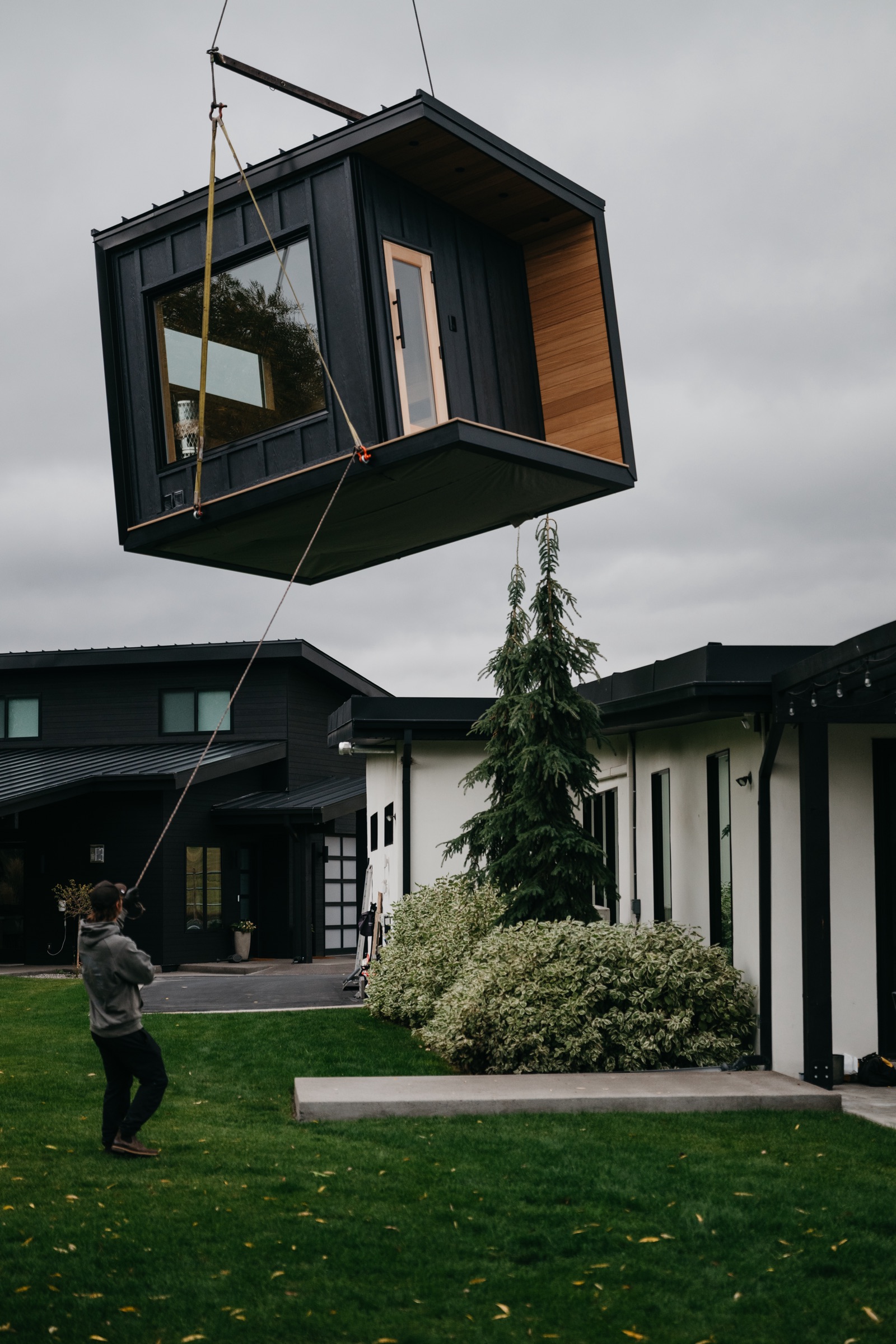 Crane carrying the 212 Designer over the home