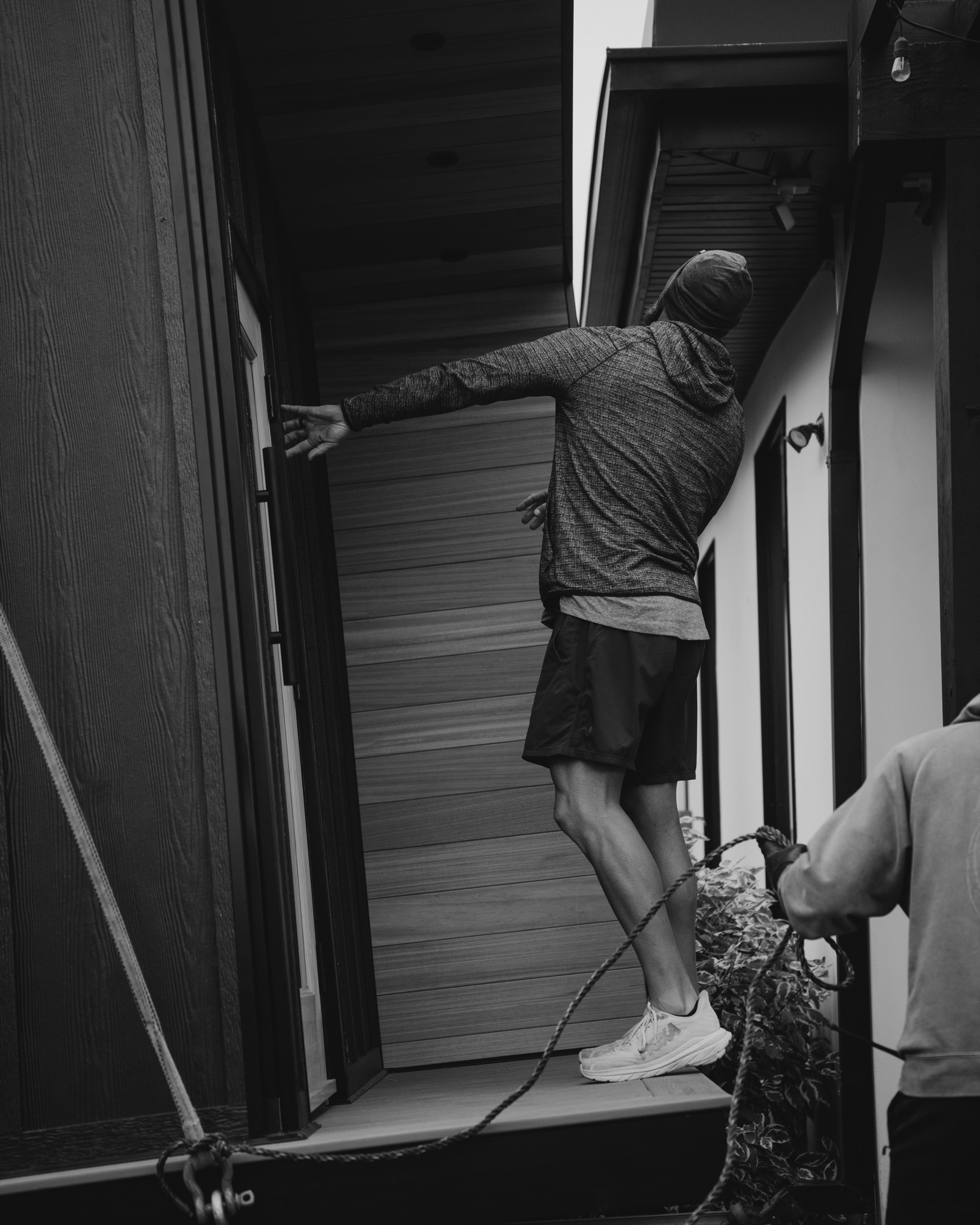 Crew member releasing the rigging on the porch