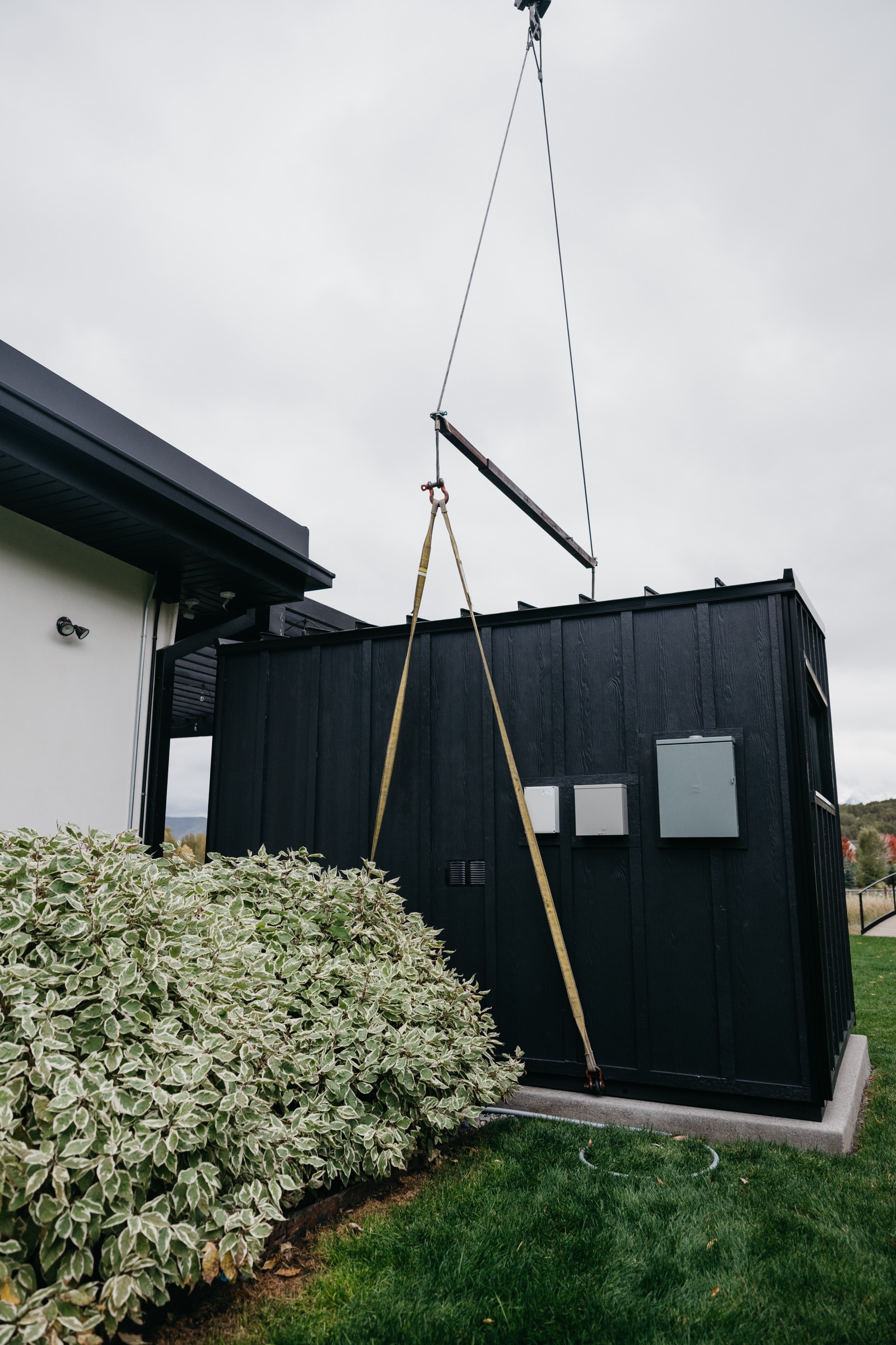 The 212 Designer seated on its pad beside the home