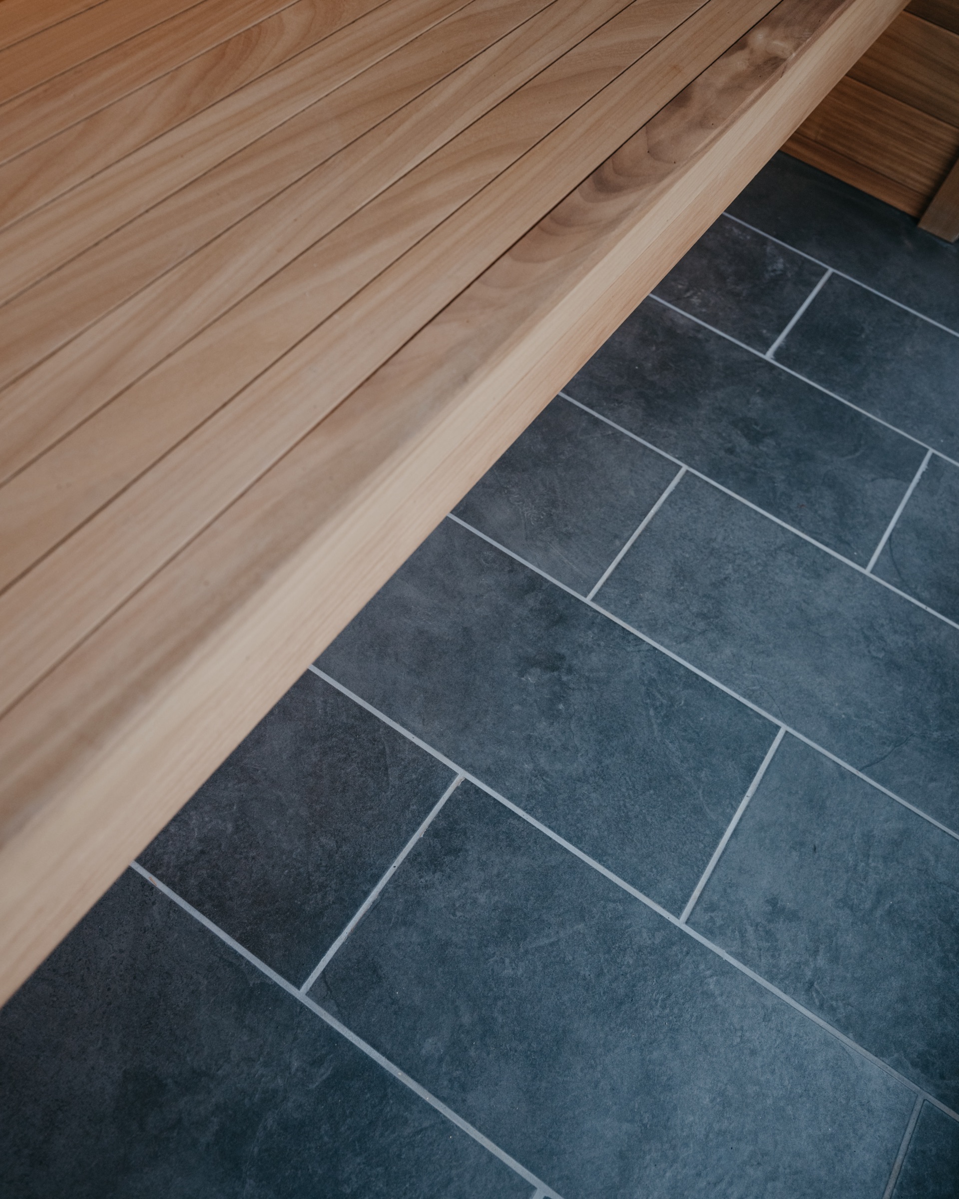 Slate tile floor meeting the cedar bench