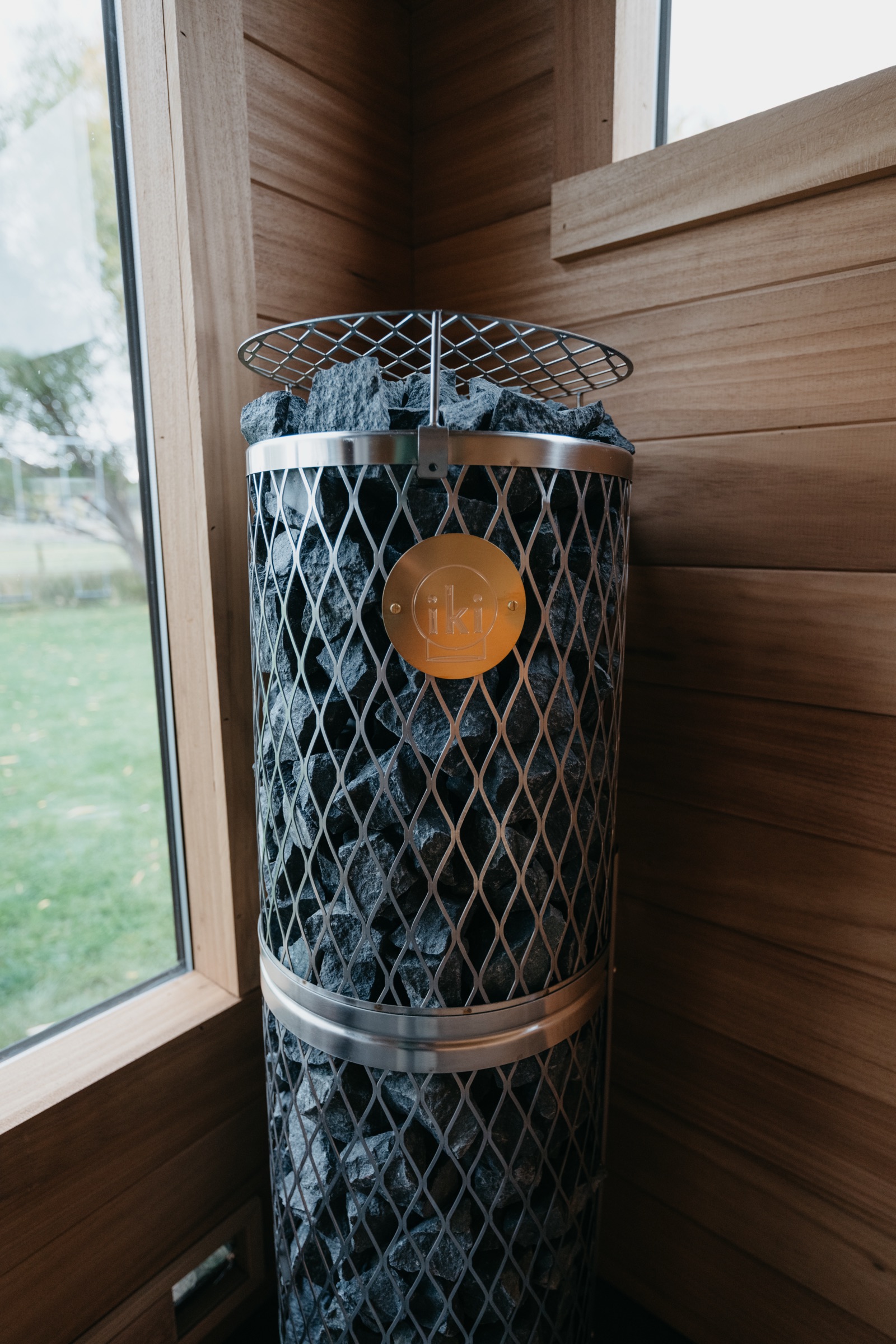 Heater and stone basket against the cedar wall