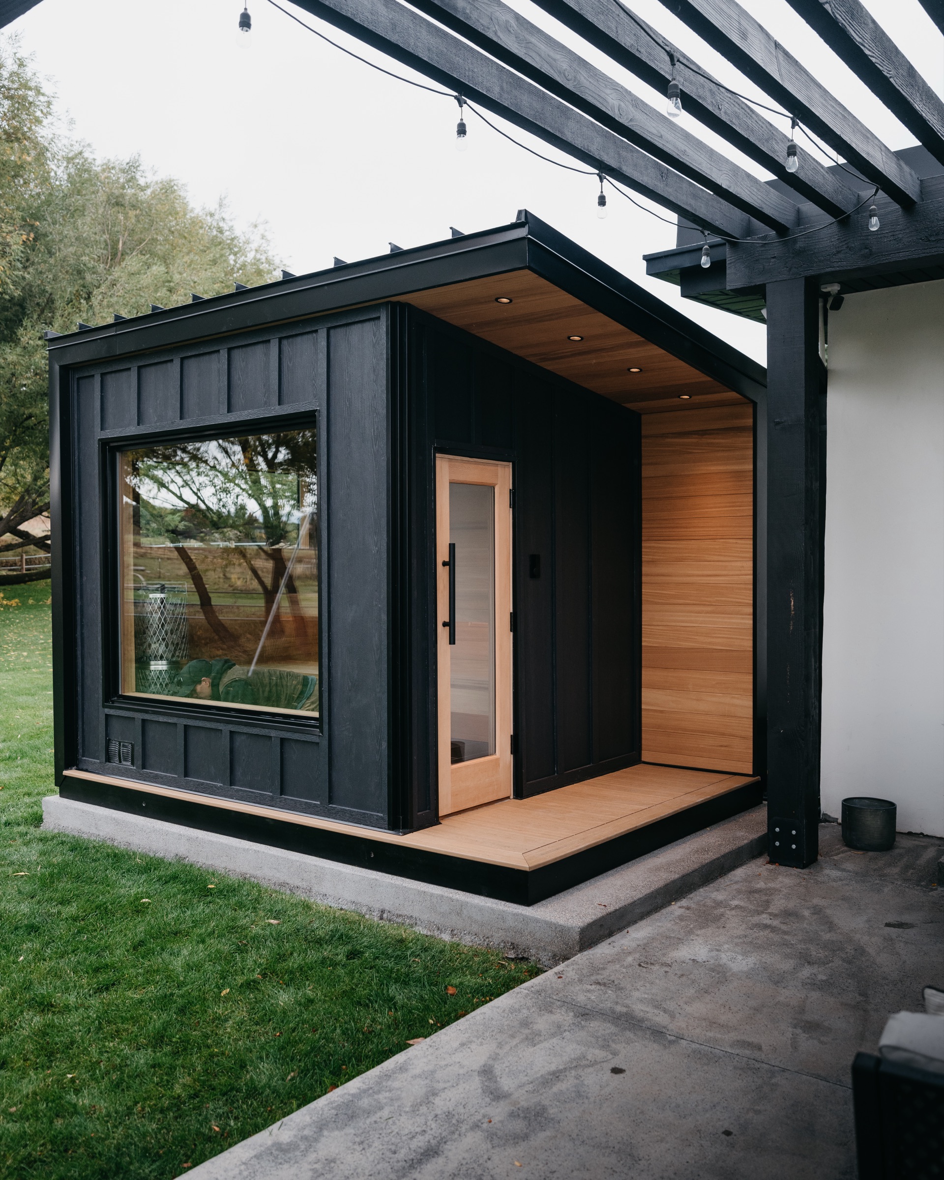 Covered porch and cedar door from the yard
