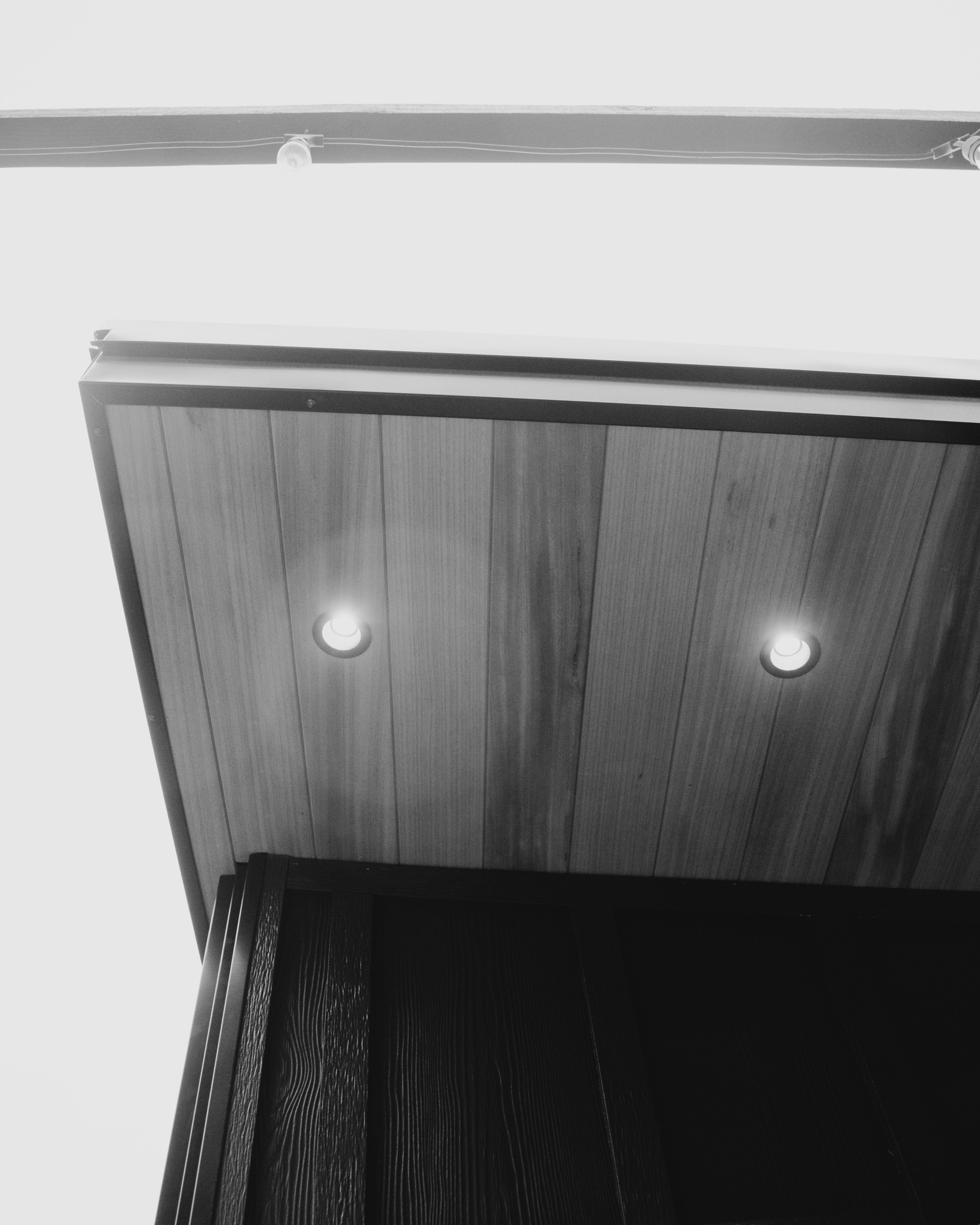 Lit cedar soffit above the porch